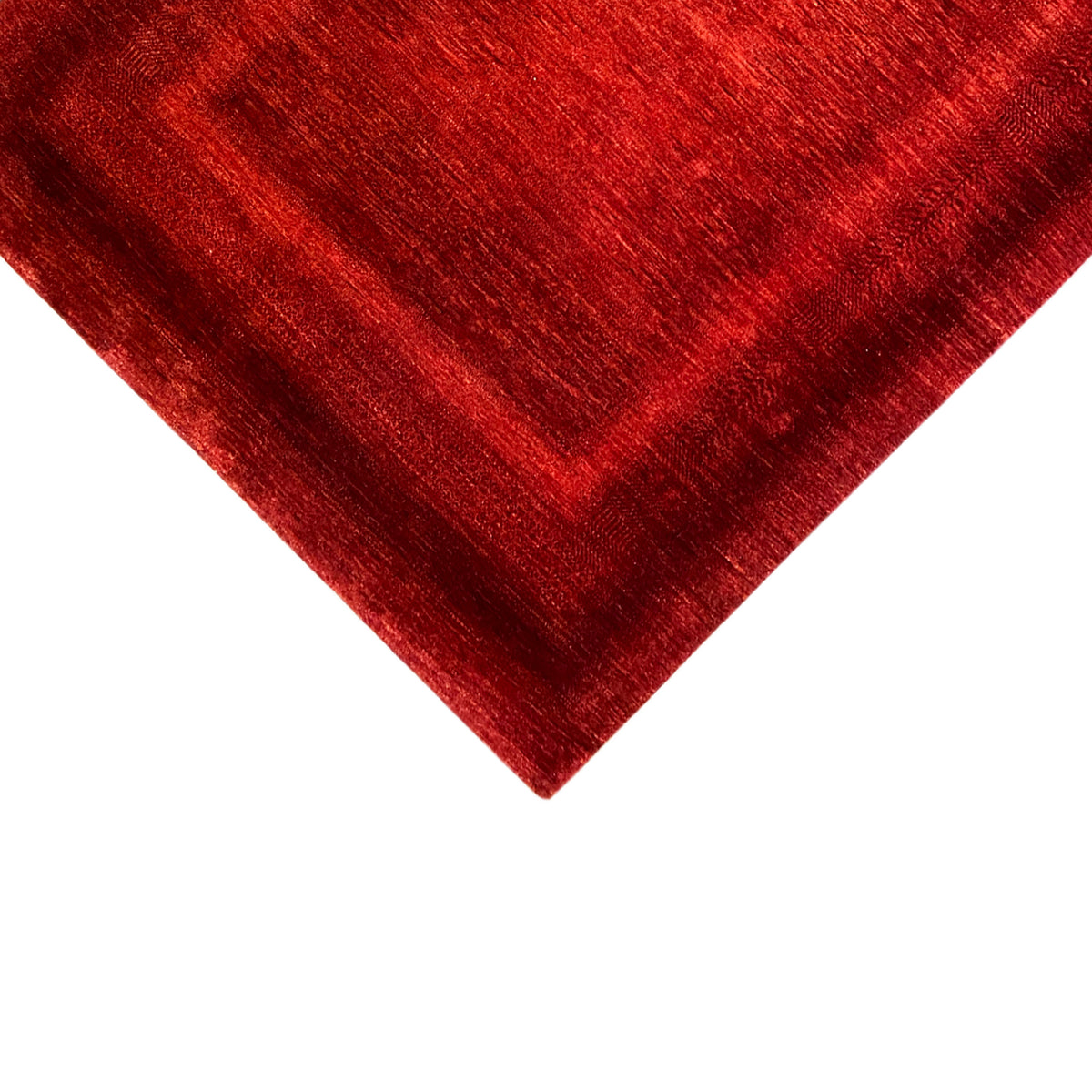 Red carpet from the corner, visible pile texture and muted sheen