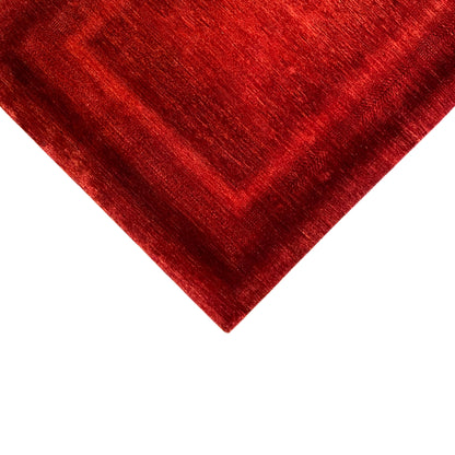 Red carpet from the corner, visible pile texture and muted sheen