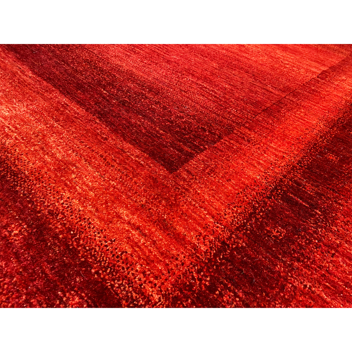Gabbeh-Luri rug: close-up of the red weave and faded pattern lines