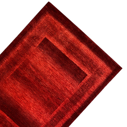 Gabbeh-Luri rug in red, close-up of the central frame and border strip.