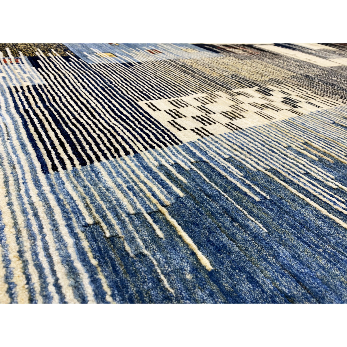 Detail view: Gabbeh rug with fine lines and patterns in blue and cream