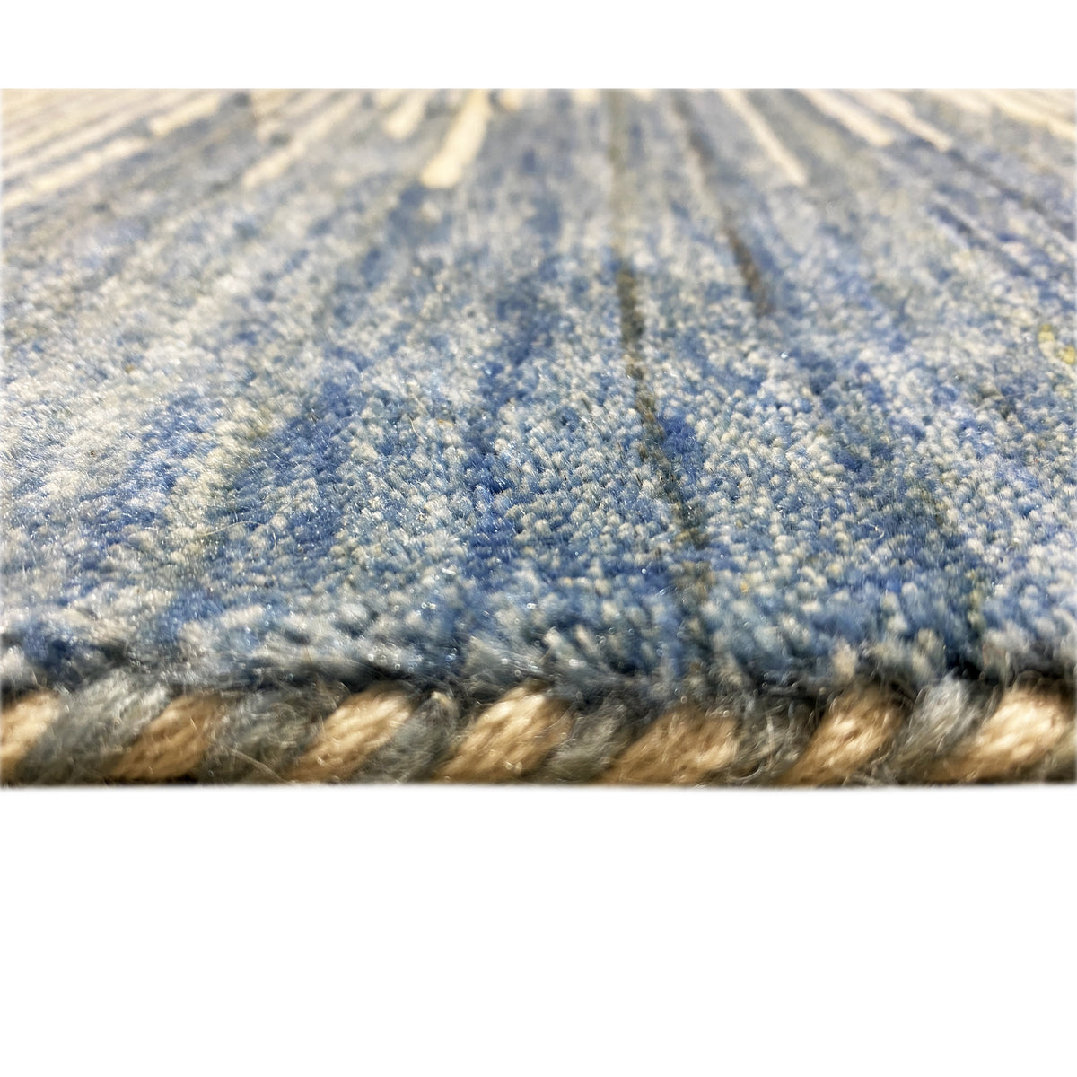 Close-up of the carpet surface with blue-gray fibers and a short pile