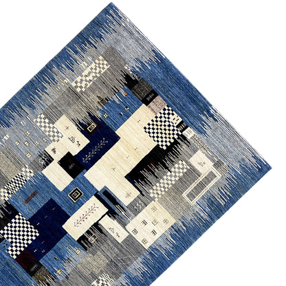 Gabbeh rug detail with patchwork motifs in blue, cream, and black