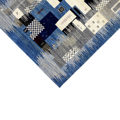 Partial view of the Gabbeh rug with geometric fields in blue and cream