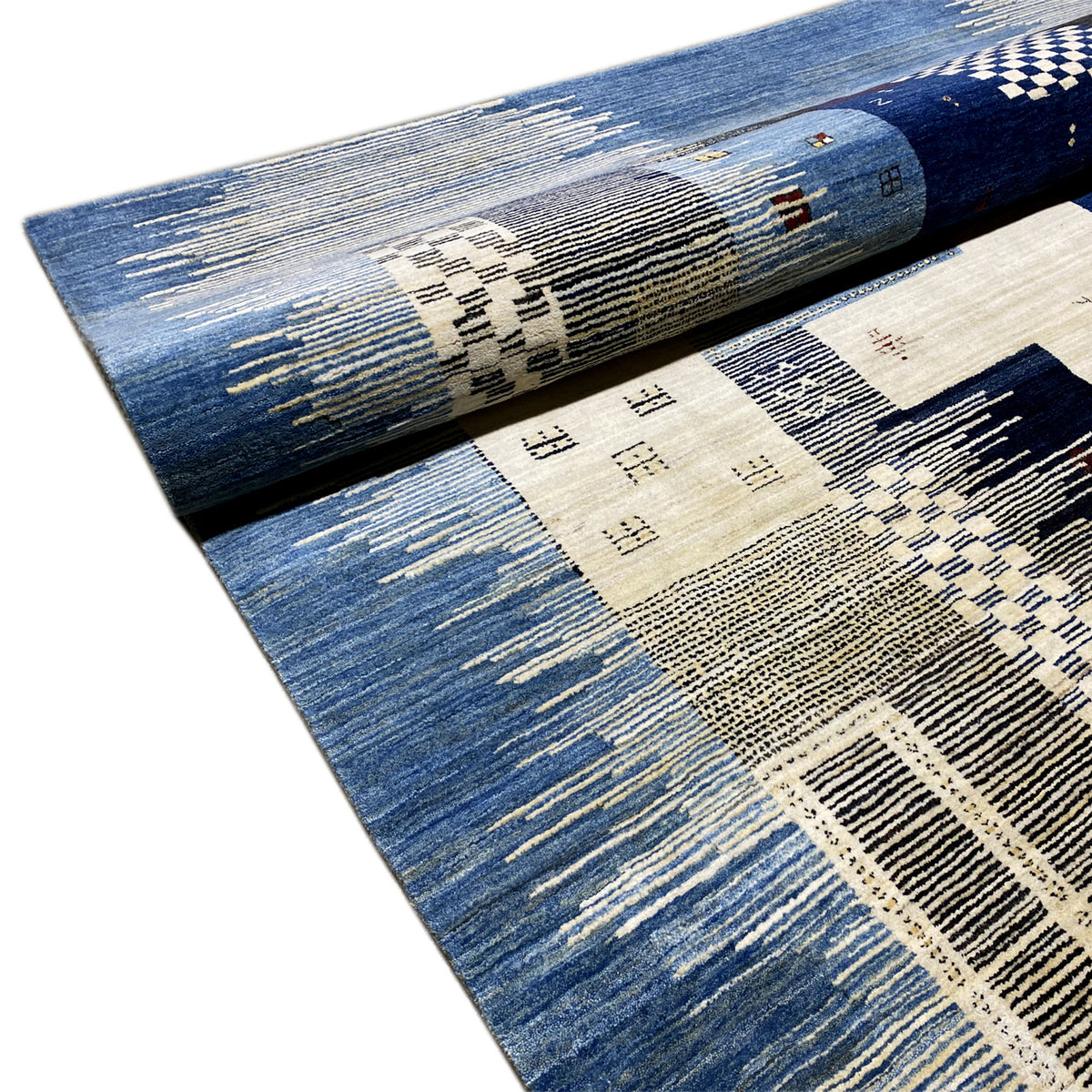 Corner and border detail of the blue Gabbeh rug with beige patterned areas