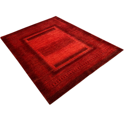 Gabbeh Luri rug in red with a square central medallion and border, diagonal view