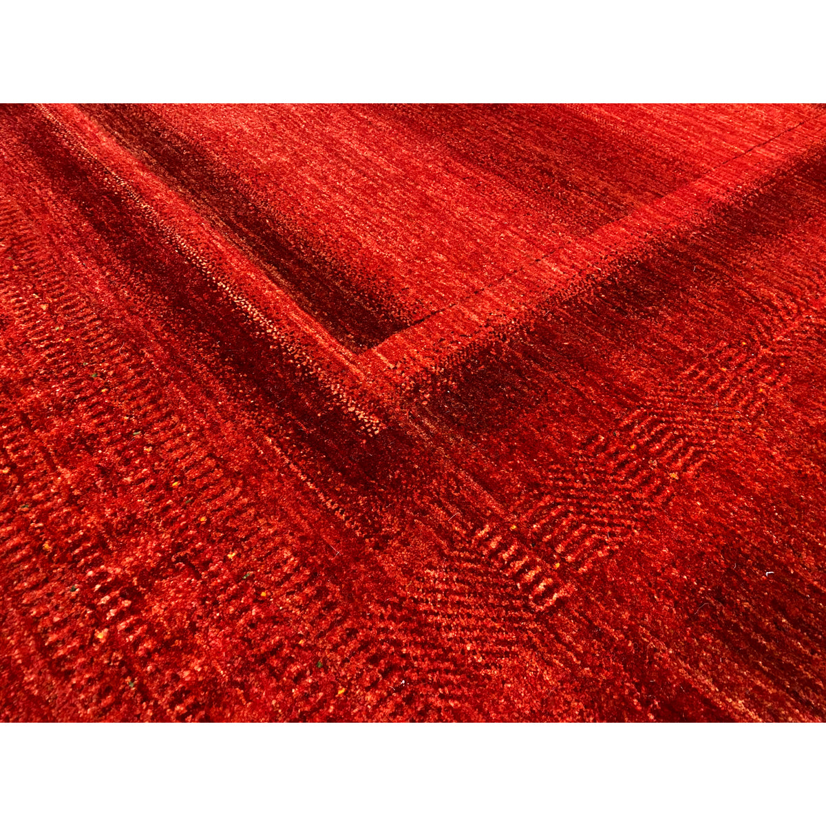 Gabbeh Luri rug in red: detailed view of the woven texture and lines in the pattern