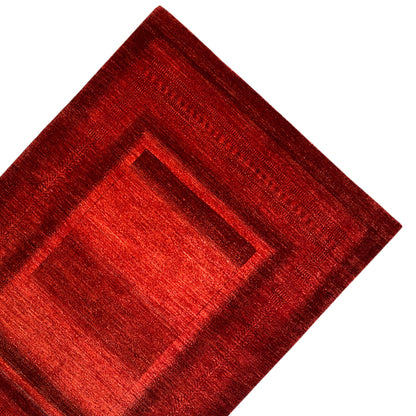 Gabbeh-Luri rug, red with a central square and border, close-up
