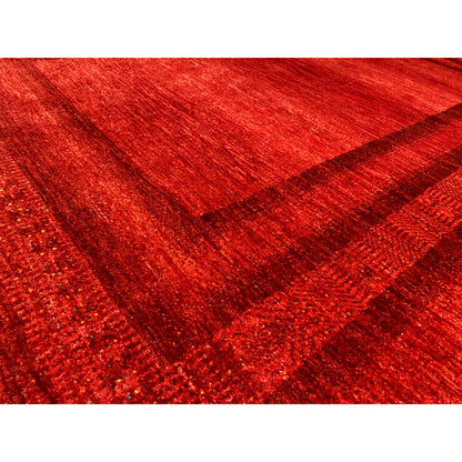 Detailed view of red Gabbeh-Luri rug with a woven texture and multilayered patterned lines