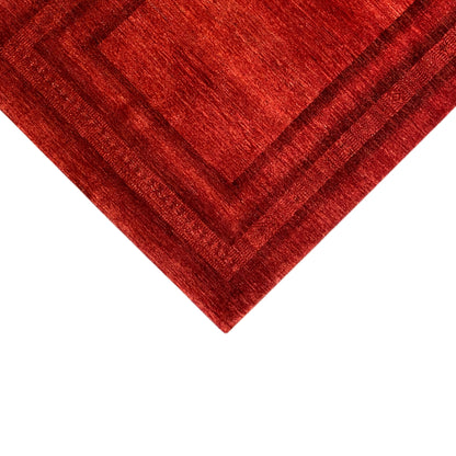 Detail of the red carpet edge: Gabbeh-Luri design with a surrounding border and central frame