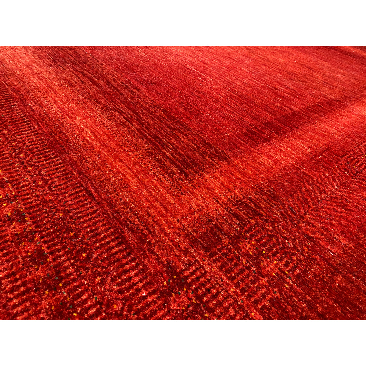 Close-up: Red carpet with a dense, mottled surface and fine woven lines