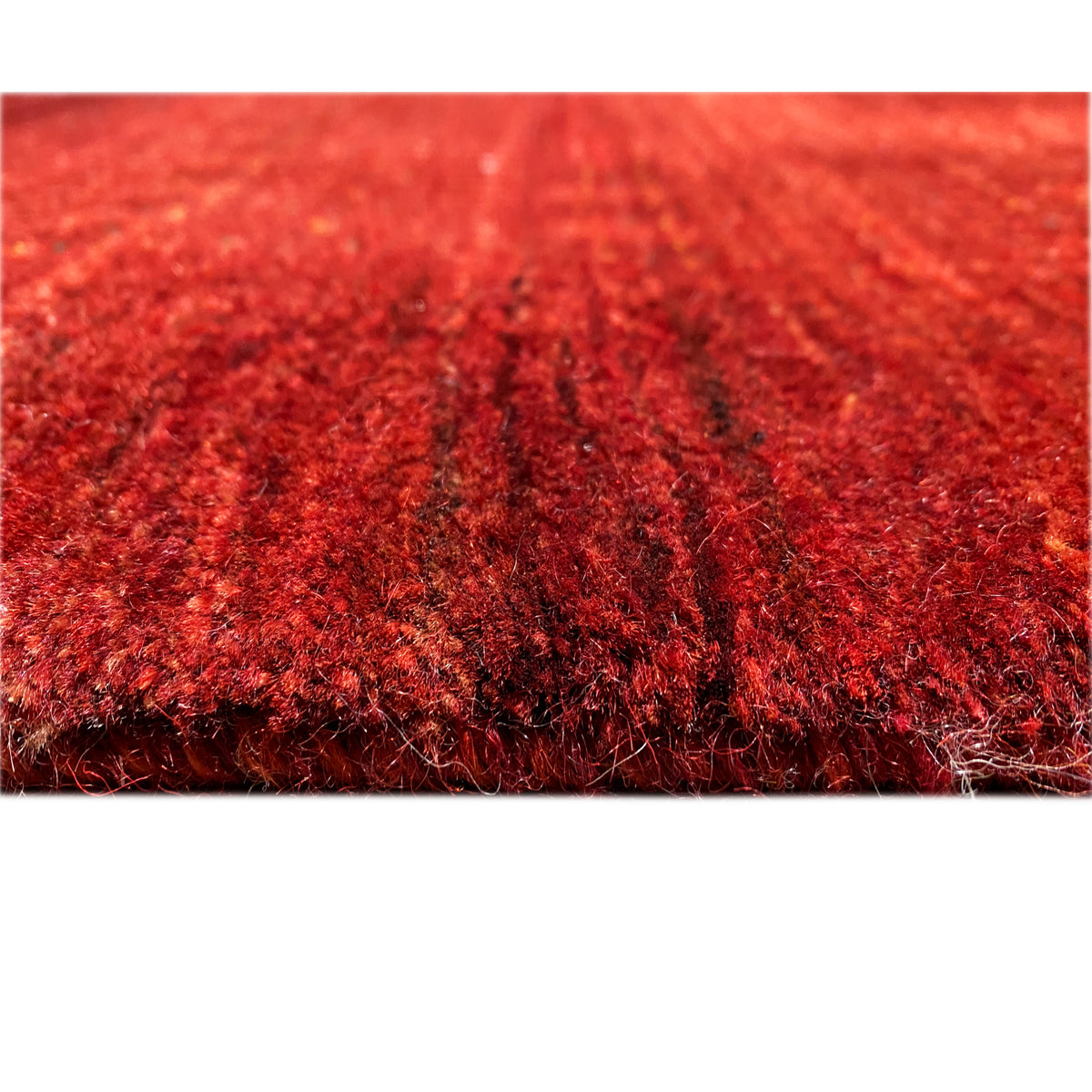 Close-up of the carpet surface: dense red pile with a textured finish
