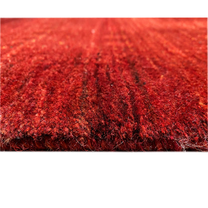 Close-up of the carpet surface: dense red pile with a textured finish