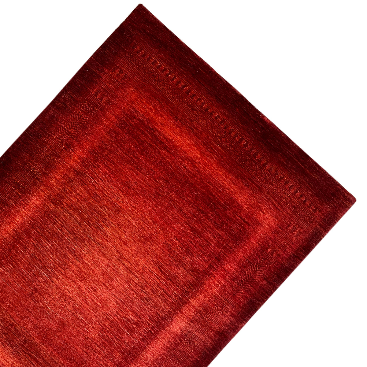 Red carpet with a fine linear pattern and woven edge finish, shown at a diagonal angle
