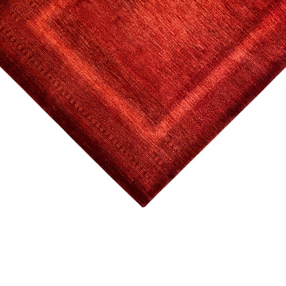 Close-up: red carpet with a woven relief and uniform grain along the edge