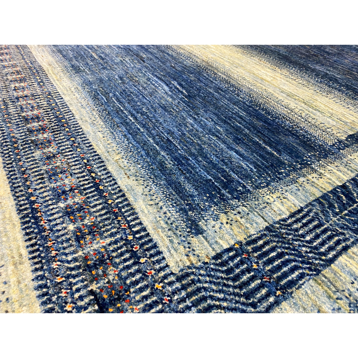 Gabbeh-Luri rug detail border, blue-and-cream pattern with colorful accents