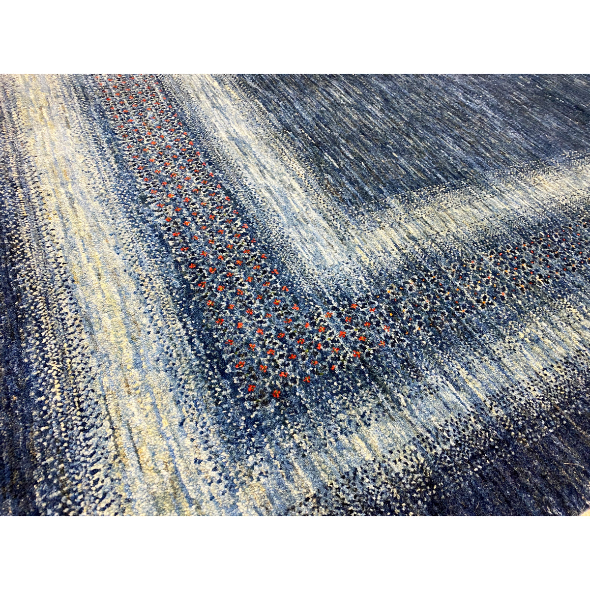 Carpet detail: blue and light-colored stripes with a patterned woven texture