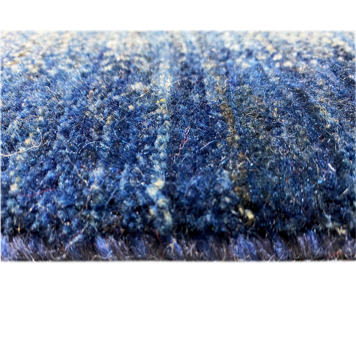 Blue carpet surface with a dense, textured pile structure