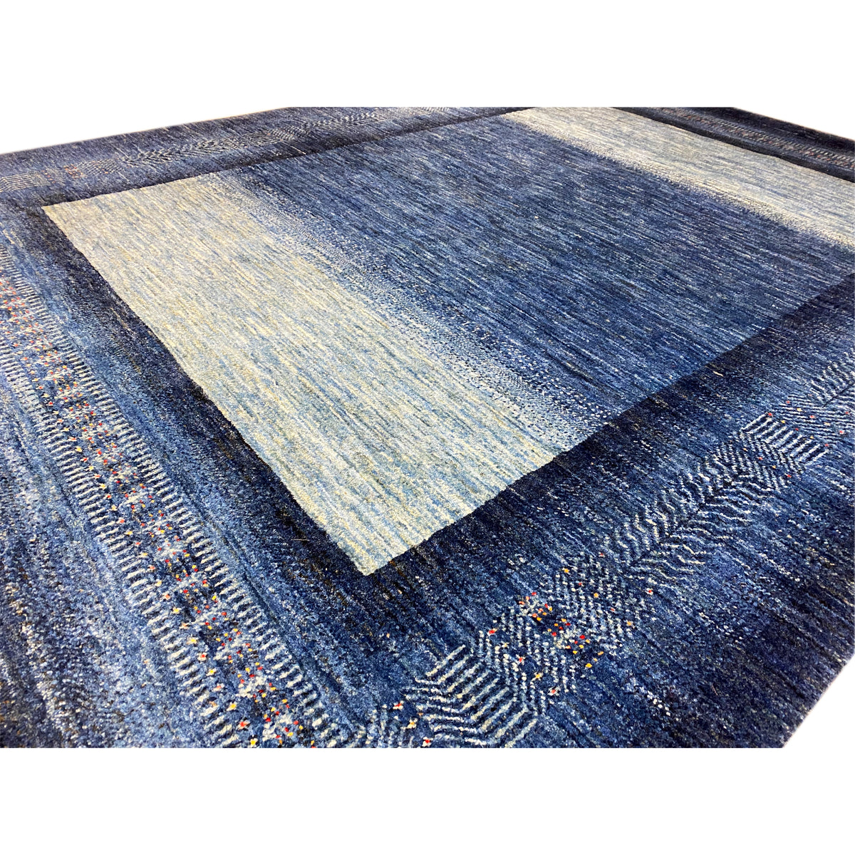Rug 214x164 cm close-up: blue all-over pattern, textured wool, accent colors