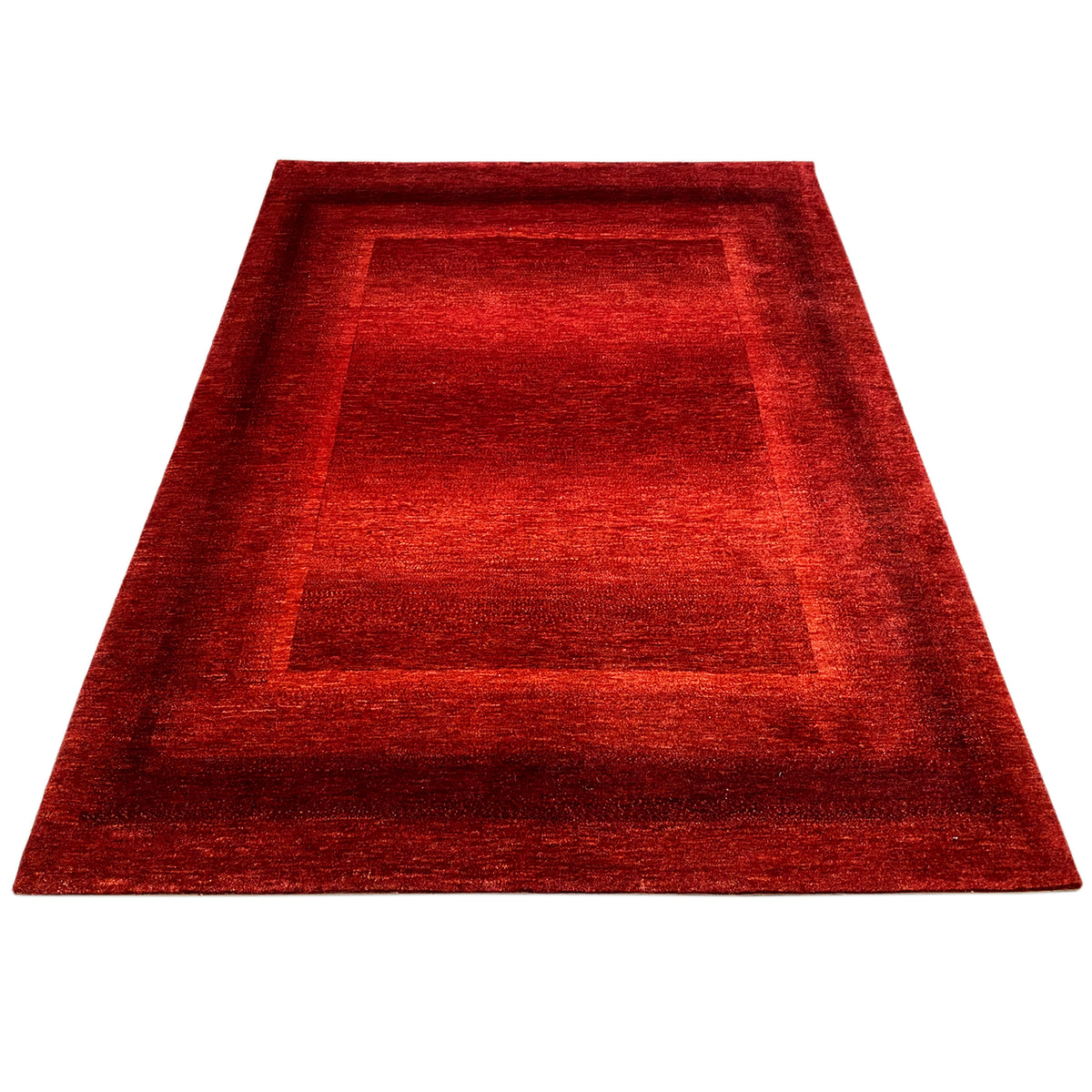 Red carpet with a rectangular medallion in the frame, photographed in a trapezoidal perspective