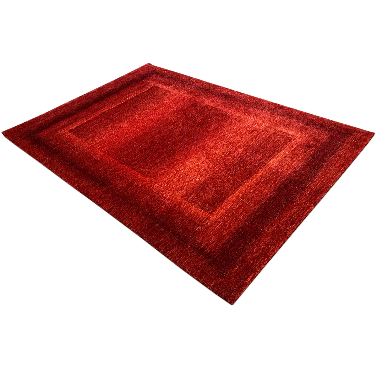 Red carpet viewed diagonally with a geometric pattern and border