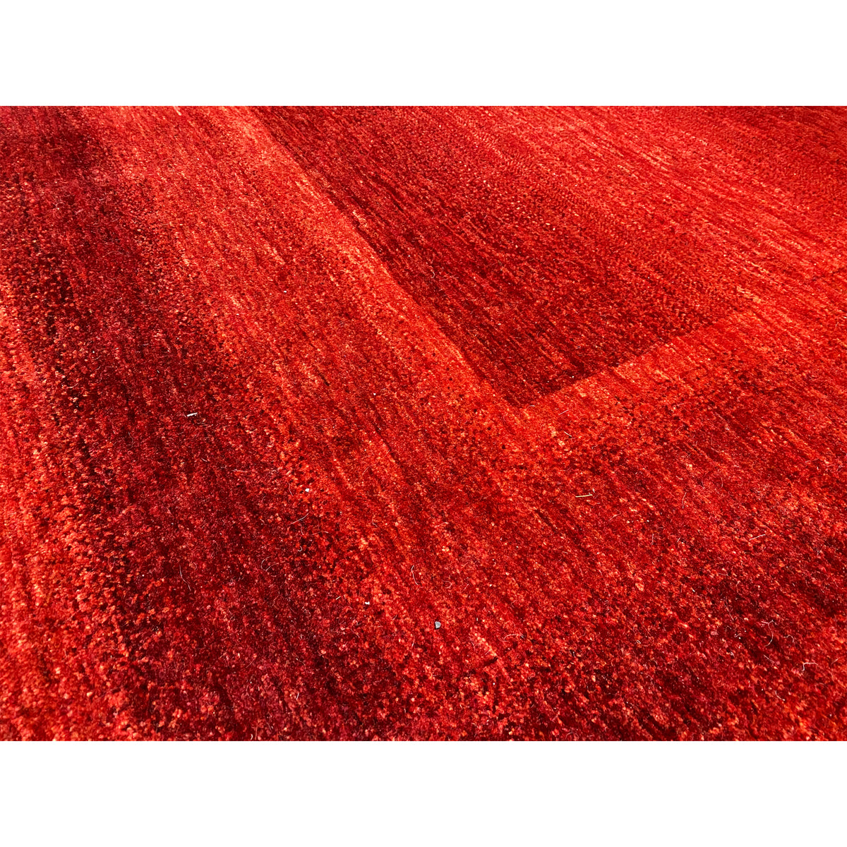 Close-up: Red carpet with a fine pile texture and visible pattern lines