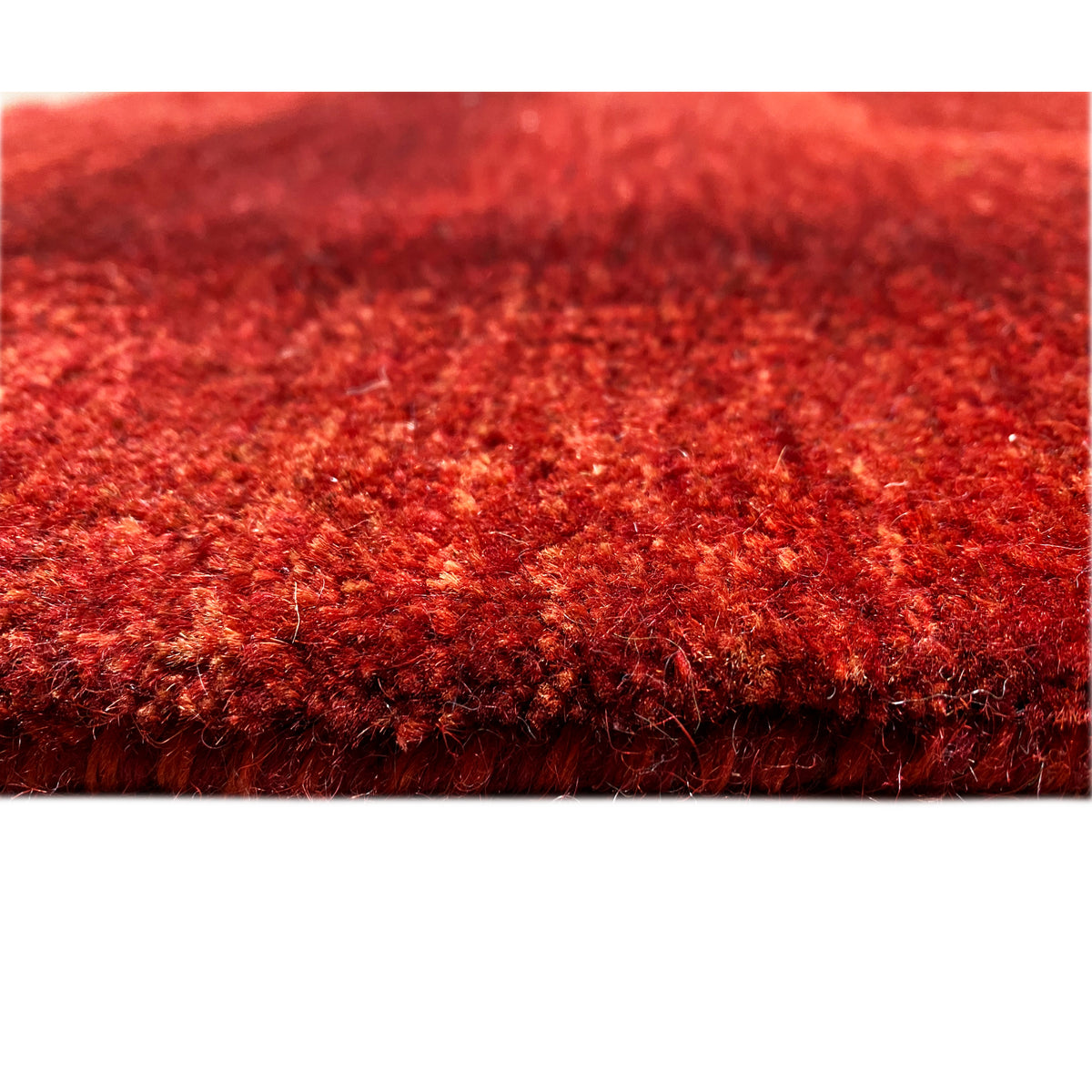 Close-up of the carpet surface: dense red pile with an even texture