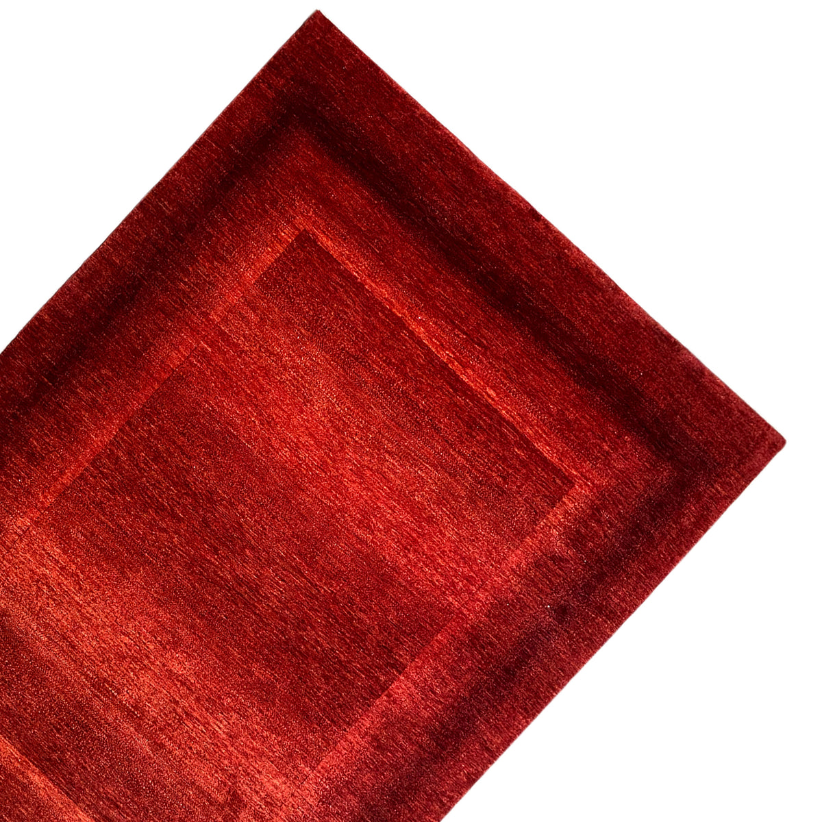 Close-up of a red carpet pattern with a central square and wide border