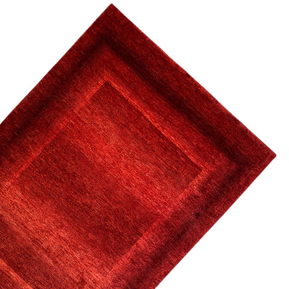 Close-up of a red carpet pattern with a central square and wide border