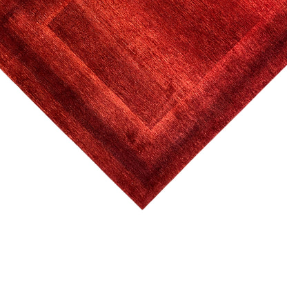 Close-up: red carpet with a diagonal fold and delicately drawn pattern