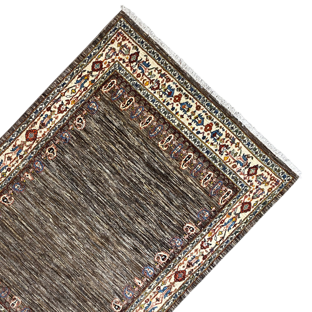 Rug laid out: brown inner field with gold/beige ornaments and finished edges