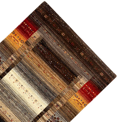 Carpet detail with an aged-looking pile, shades of brown, and red and yellow stripes