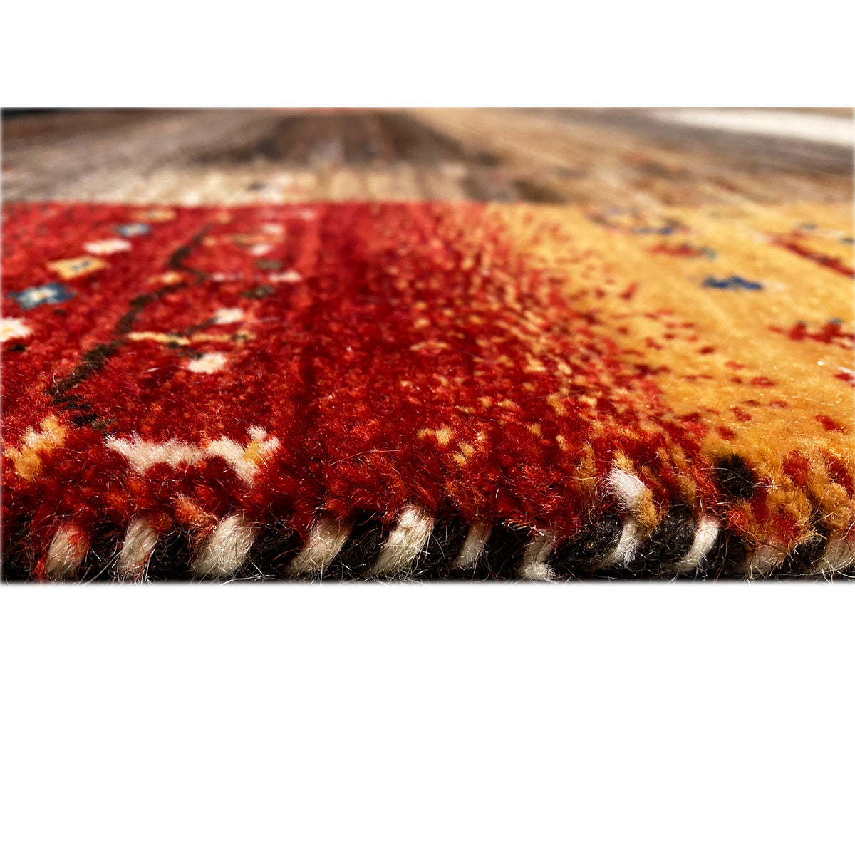 Carpet edge in detail, woven texture with red and beige patterns
