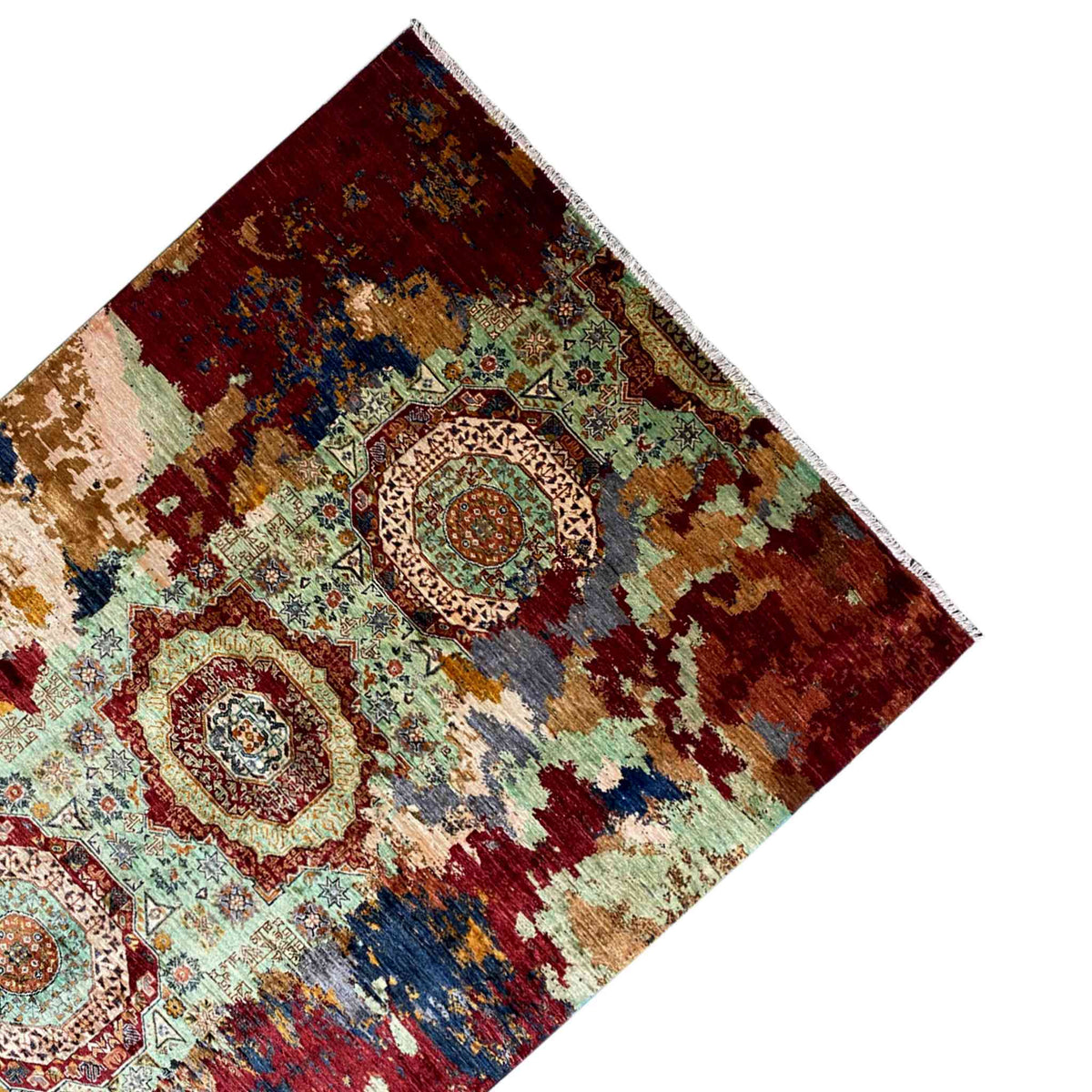 Hand-knotted Mamluk rug, viewed from an angle above: red field with a central circular medallion
