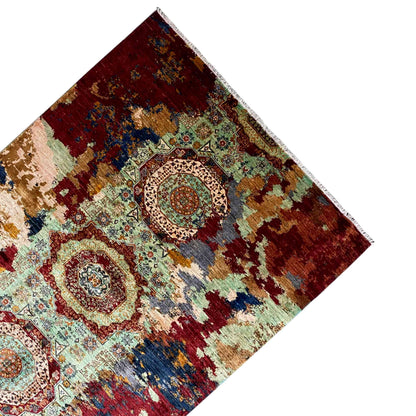 Hand-knotted Mamluk rug, viewed from an angle above: red field with a central circular medallion