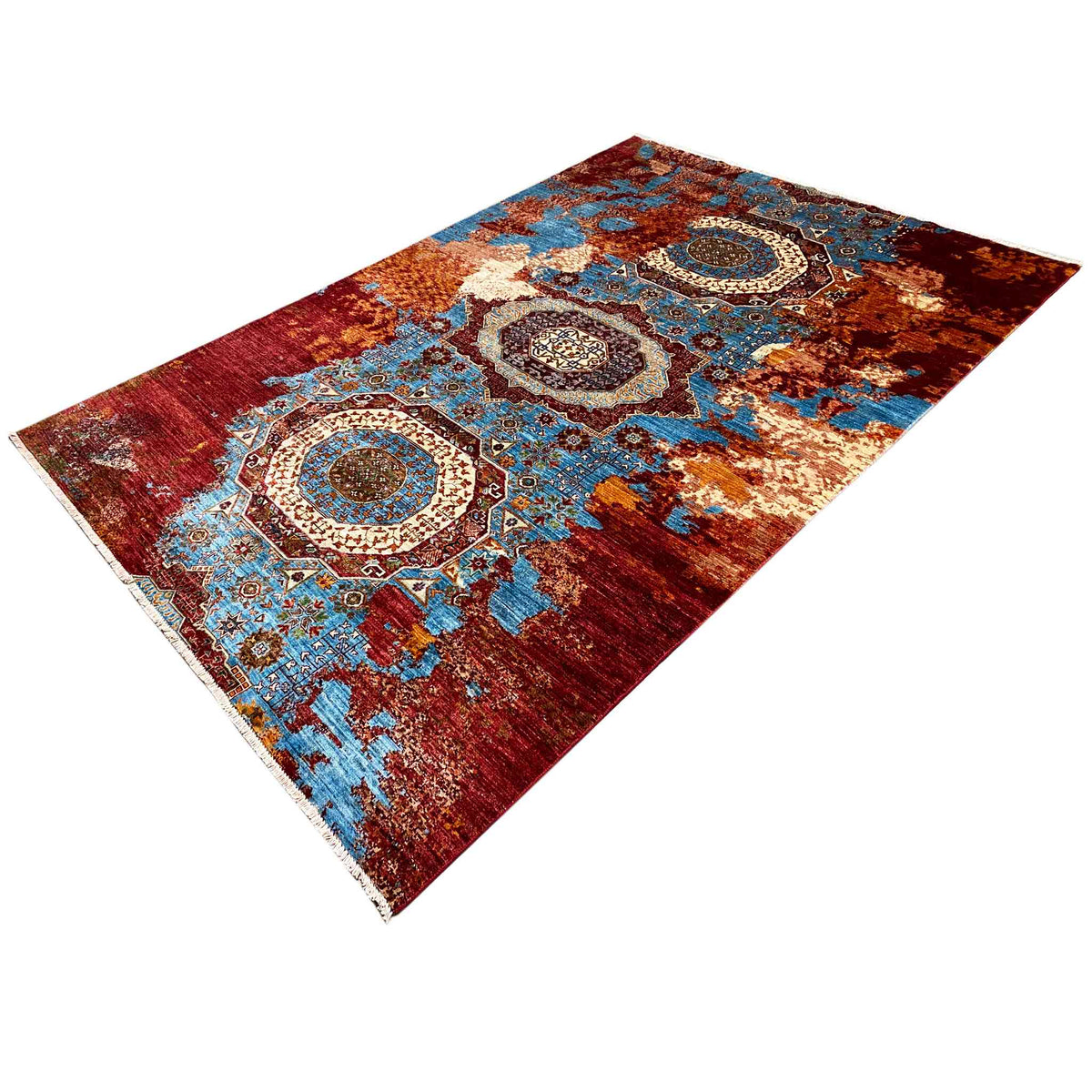 Rug with central medallions and an ornamental border, red and turquoise accents
