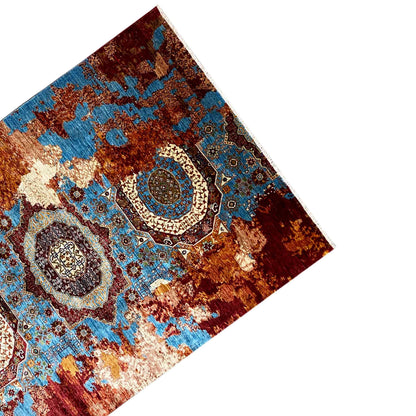 Rug viewed from an angled perspective with an oriental pattern in blue and red