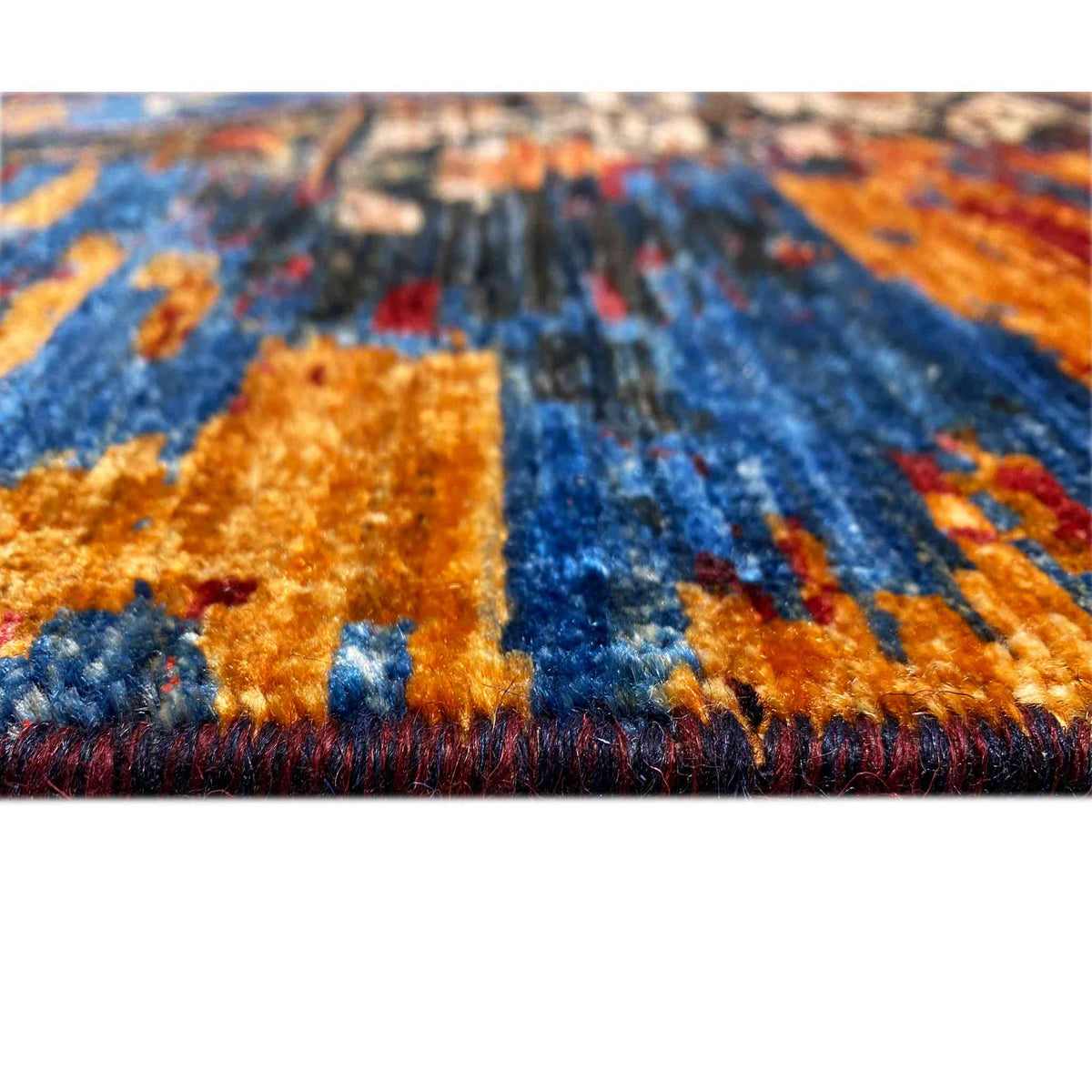 Afghan Mamluk carpet, detail view: pile with a colorful pattern in blue, orange, and beige