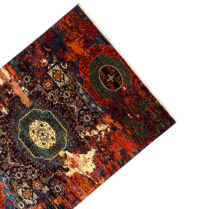 Afghan Mamluk carpet, corner view: medallion and ornaments in orange and blue