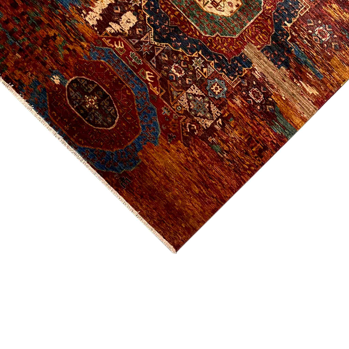 Close-up of a Mamluk carpet corner, rust-brown with a blue medallion and border pattern