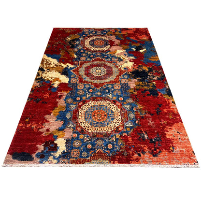 Rectangular rug with a red background, blue ornamental fields, and beige accents