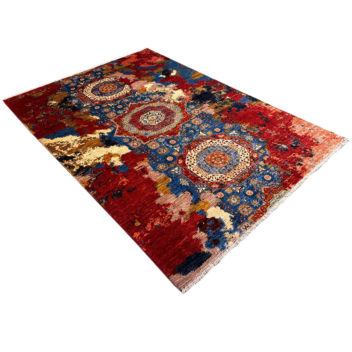 Rug with a red background, blue patterns, and beige elements, diagonal view