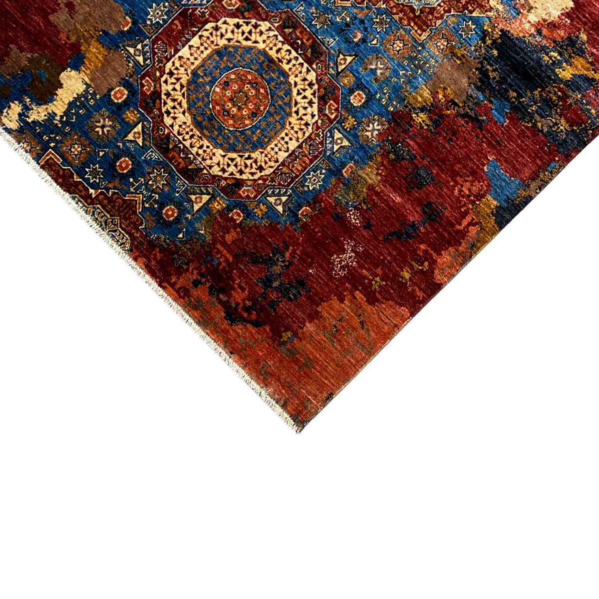 Corner view of the rug with border, central blue medallion, red and gold