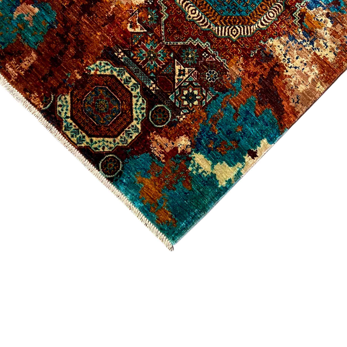 Mamluk carpet corner detail with turquoise and brown ornament and fringes along the edge