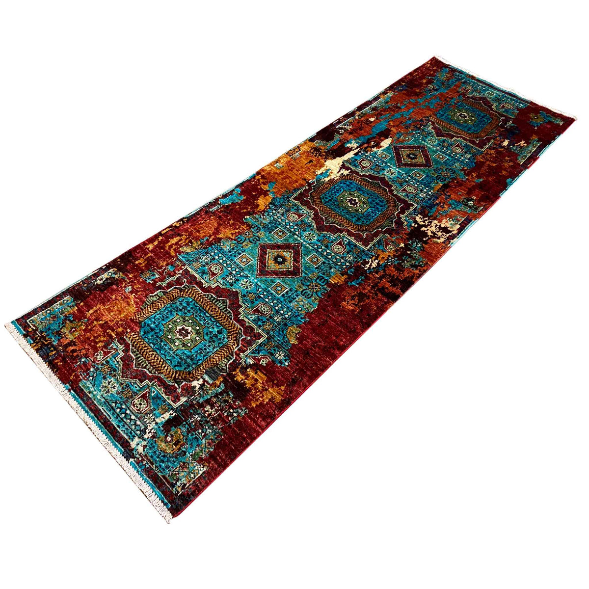 Runner rug in detail: ornamental motifs in turquoise, blue and red, with a colorful border