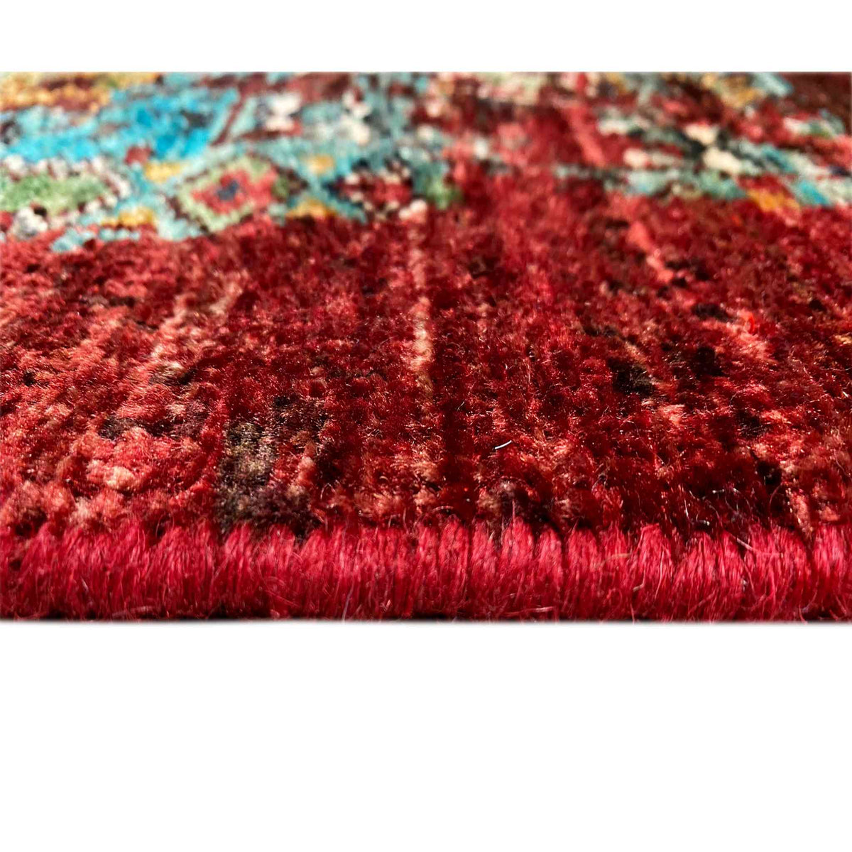 Runner rug with dense pile in vibrant red, patterned color transitions in turquoise