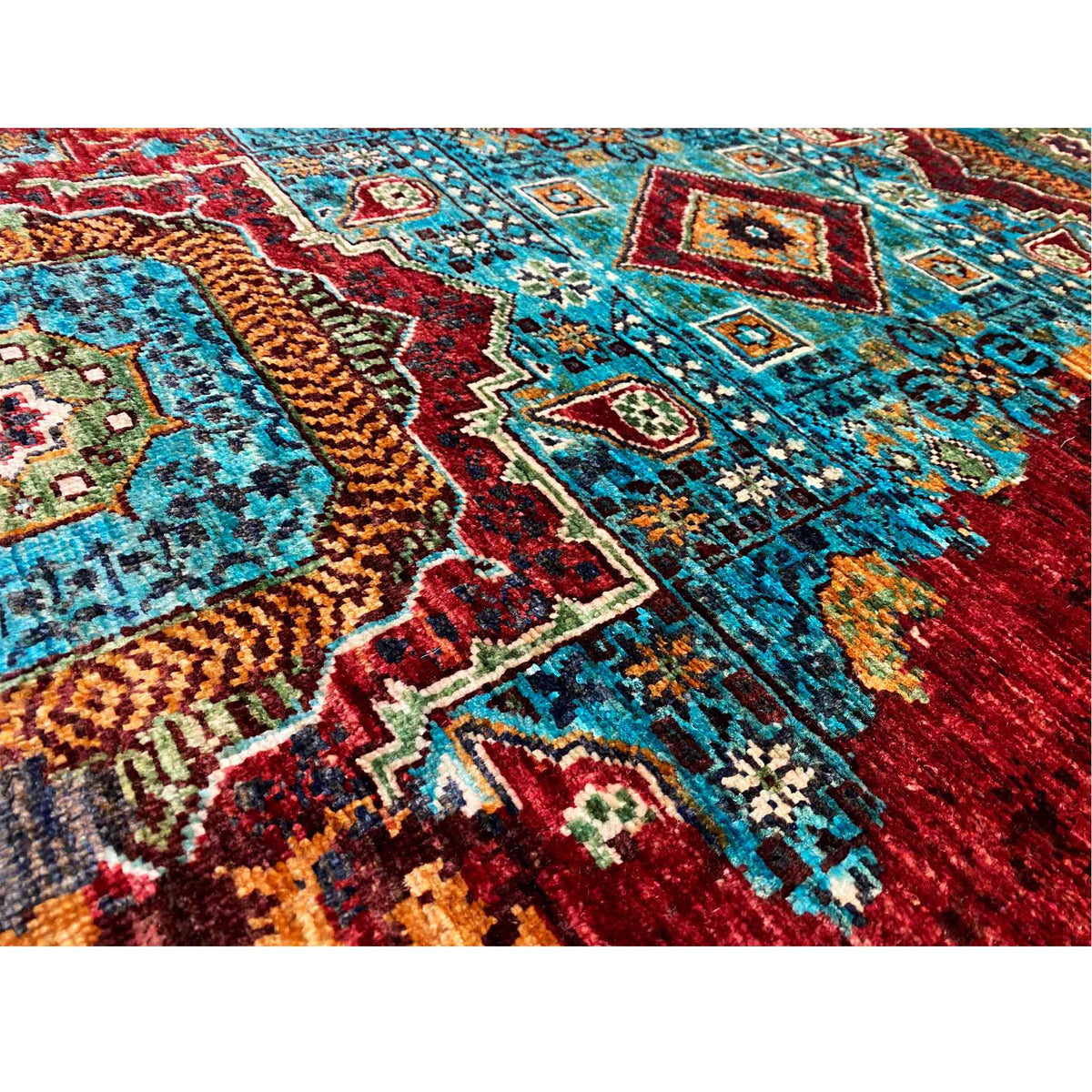 Woven runner rug with delicate ornamental details in turquoise, blue, and red, tightly woven