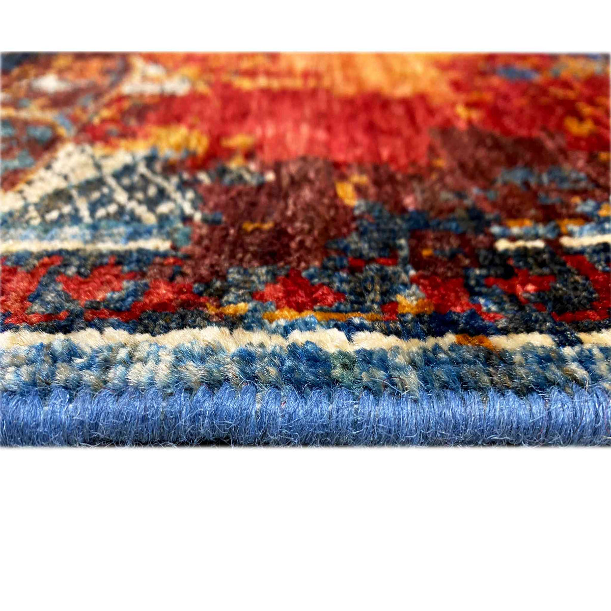 Close-up of the Mamluk runner rug: colorful pattern, curled pile along the edge