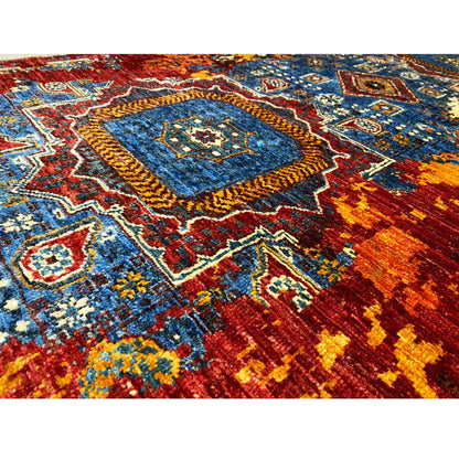 Close-up of Mamluk runner rug: bold pattern with a blue center, red and yellow tones
