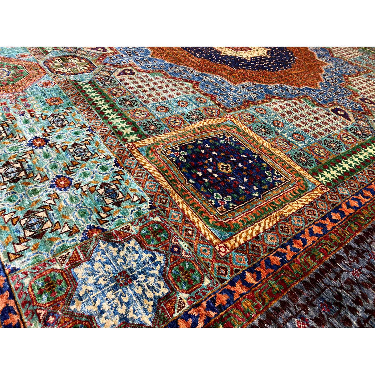 Hand-knotted Mamluk rug detail: patterned tiles in turquoise, orange, blue and green